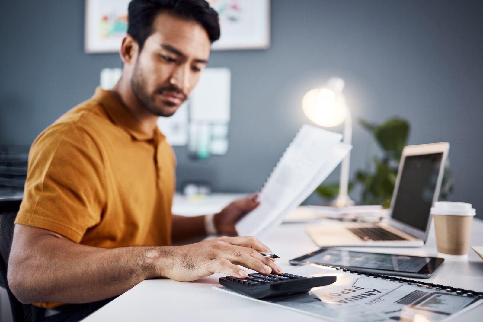 Small business owner budgeting WhatsApp campaign costs at a desk