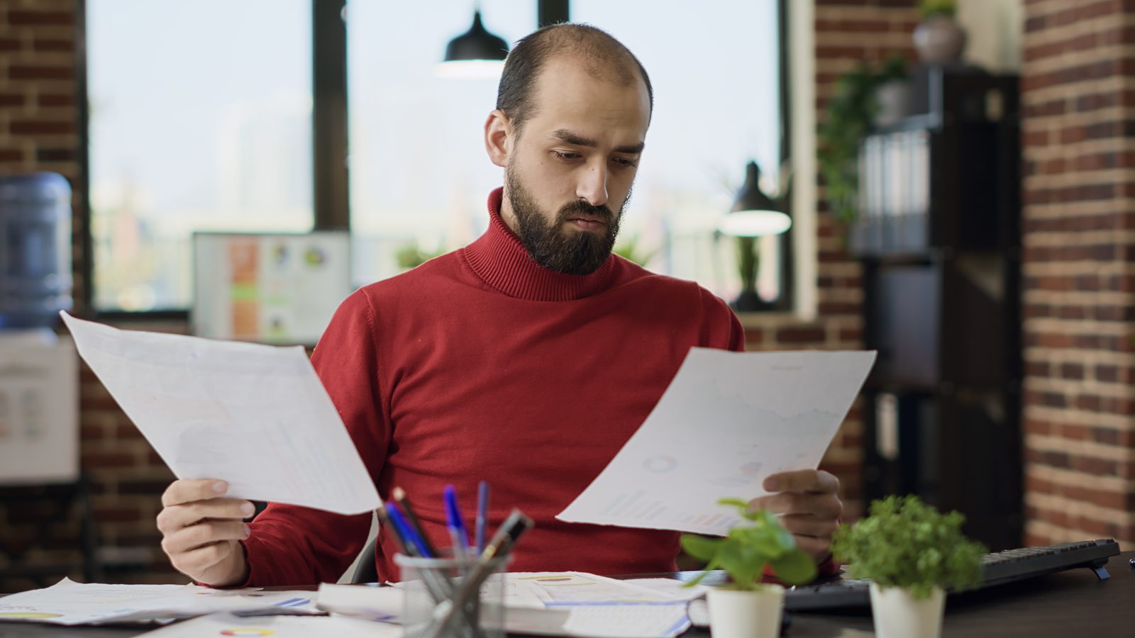 Project manager comparing supplier quotes against a dashboard